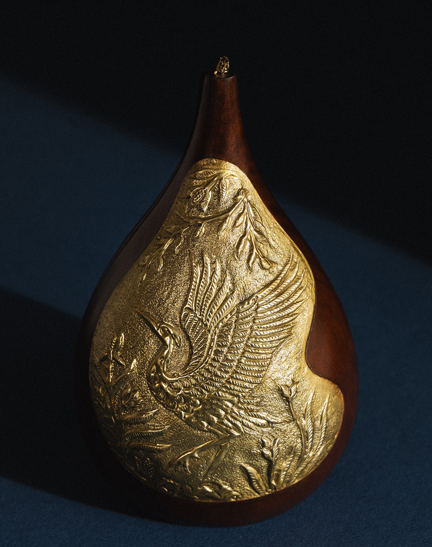 Aab Bag: a luxury handcrafted Sheesham wood and brass clutch featuring an intricately carved crane motif.